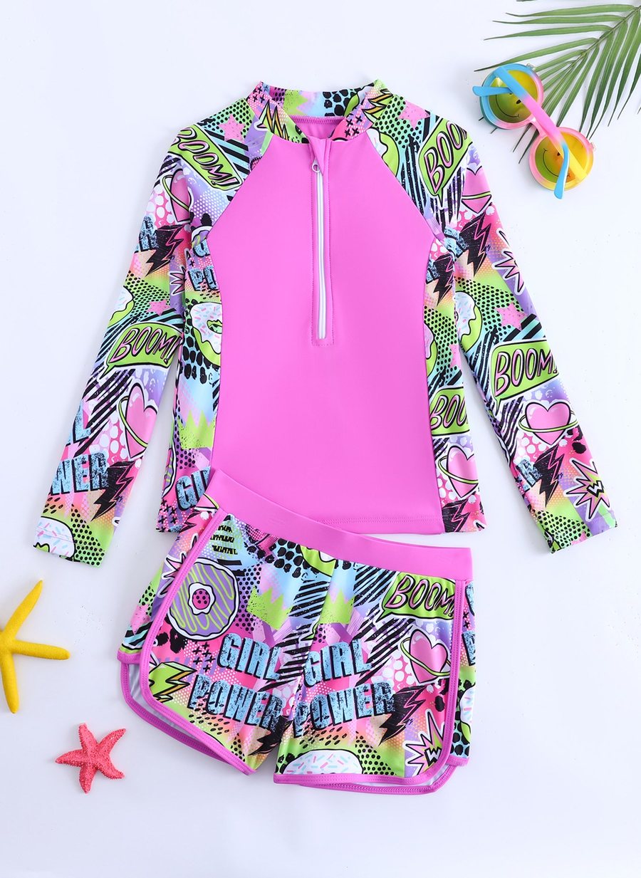 Girls' long-sleeve half-zip rash guard and swim shorts set in pink with pop-art print, front view