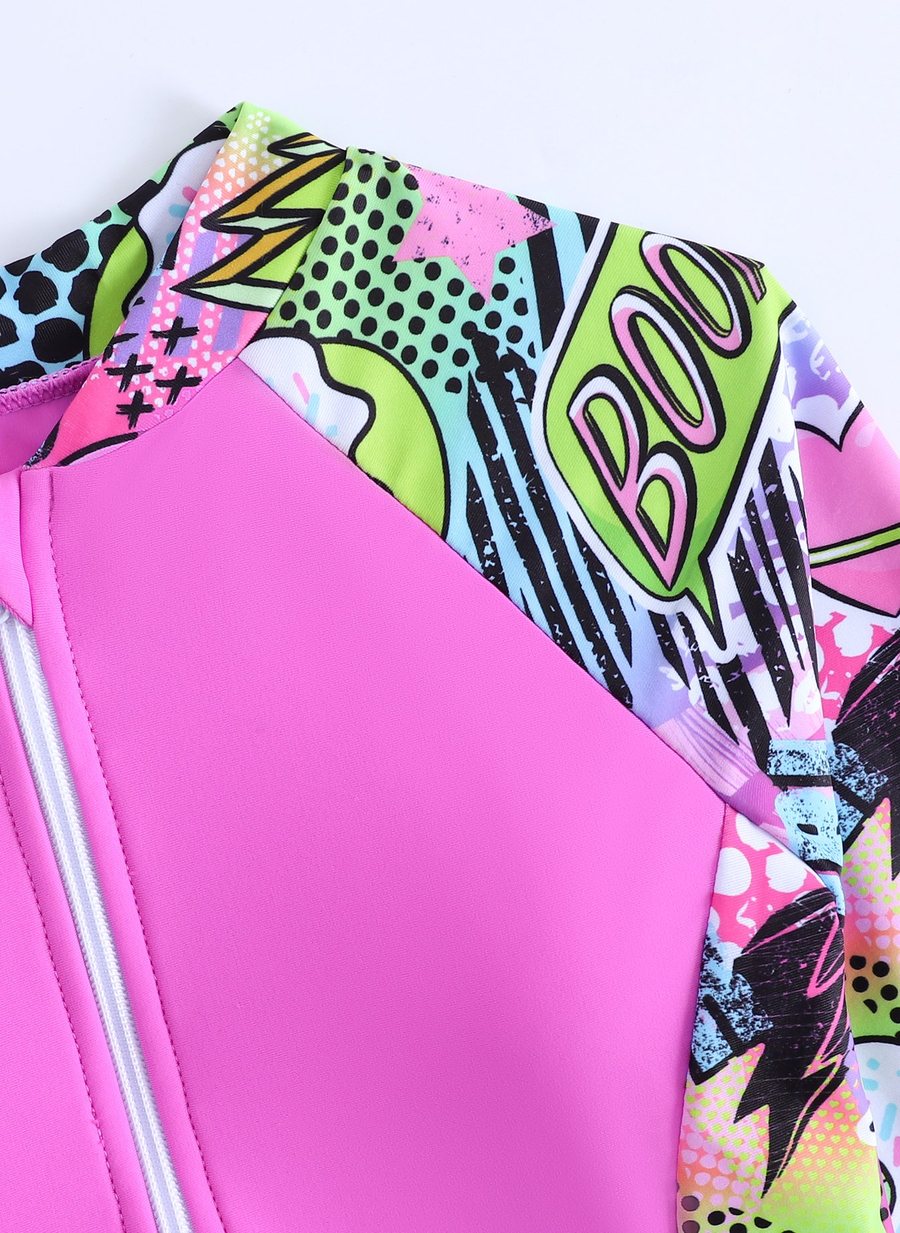 Close-up of the all-over pop-art sublimation print on the girls' rash guard sleeve